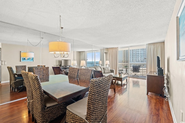 dining space featuring a textured ceiling, dark hardwood / wood-style floors, and floor to ceiling windows