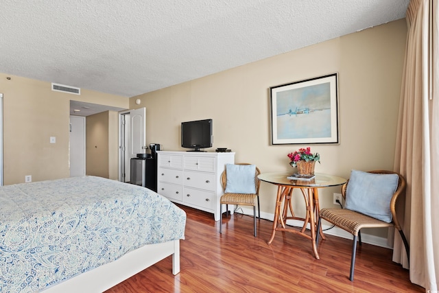 9820 Queensway Blvd Unit 903, Myrtle Beach, SC 29572 - bedroom with wood finished floors and a textured ceiling