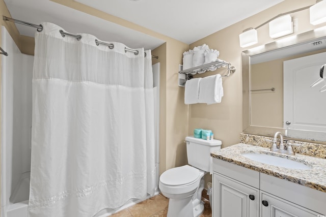 bathroom featuring tile patterned floors, vanity, and toilet