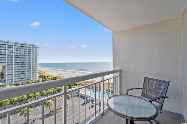 balcony featuring a water view and a view of the beach