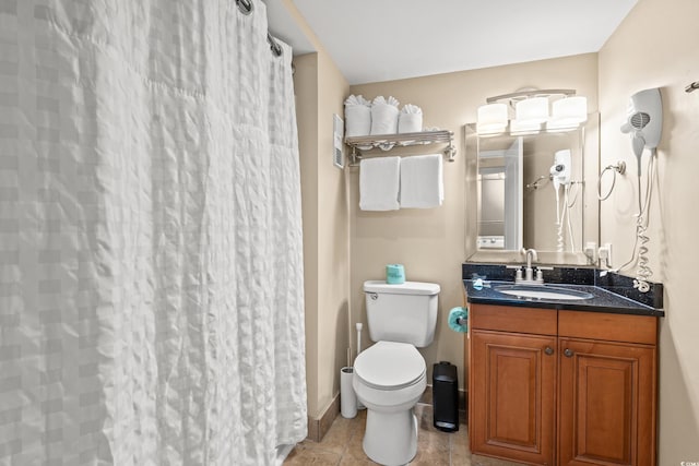 bathroom featuring tile patterned floors, curtained shower, vanity, and toilet