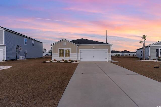 view of front of house featuring a garage and a lawn