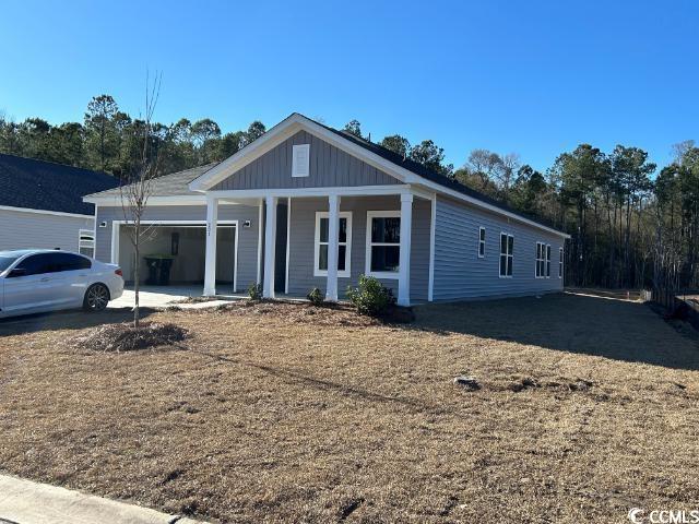 view of front of house featuring a garage and a front lawn