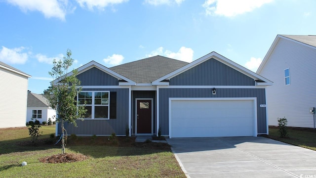 view of front of home with a front yard and a garage