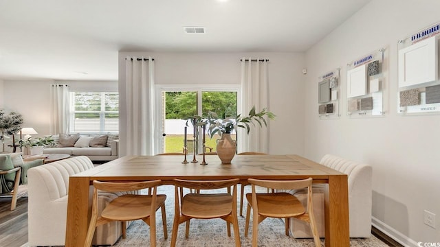 dining space with light hardwood / wood-style floors