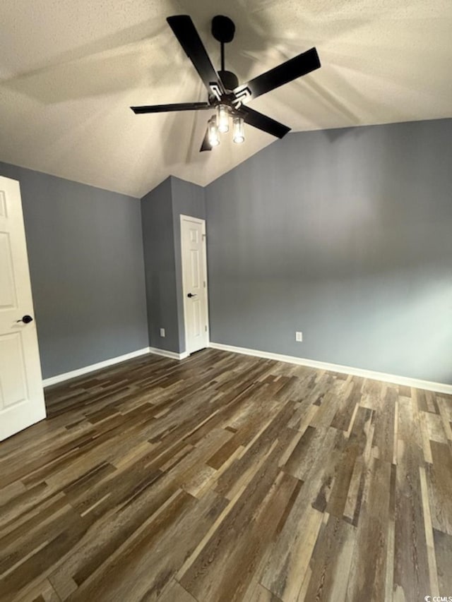 bonus room featuring a textured ceiling, vaulted ceiling, ceiling fan, and dark wood-type flooring