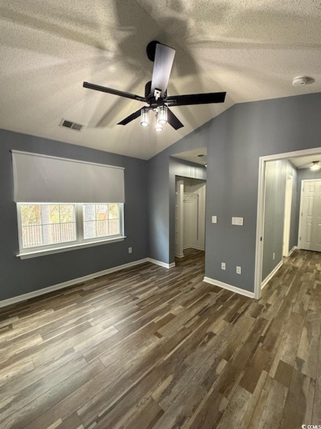 unfurnished room with ceiling fan, dark hardwood / wood-style flooring, and vaulted ceiling