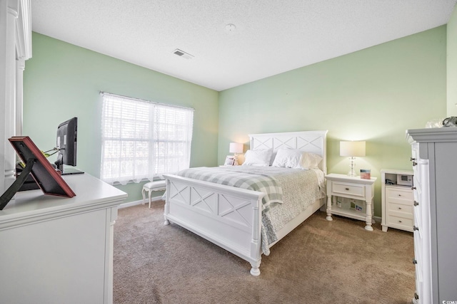 bedroom featuring carpet flooring and a textured ceiling