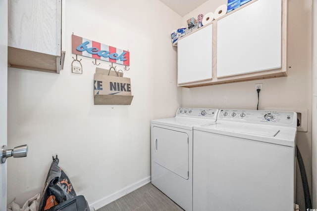 washroom with washer and clothes dryer and cabinets