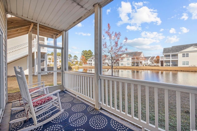 unfurnished sunroom with a water view