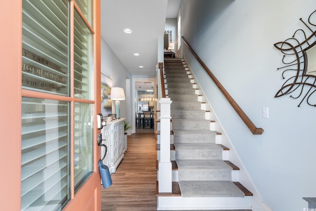 stairway featuring wood-type flooring