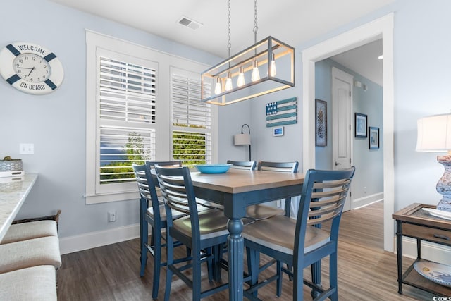 dining space with dark hardwood / wood-style flooring