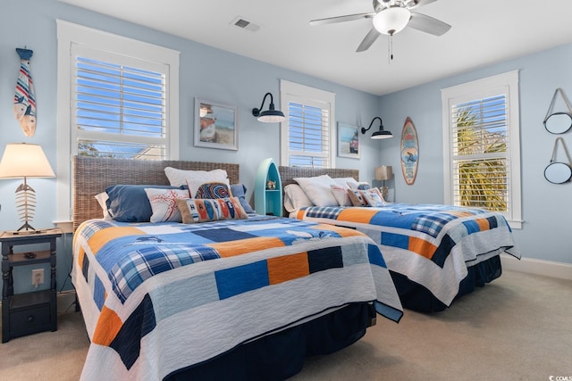 bedroom featuring light carpet and ceiling fan