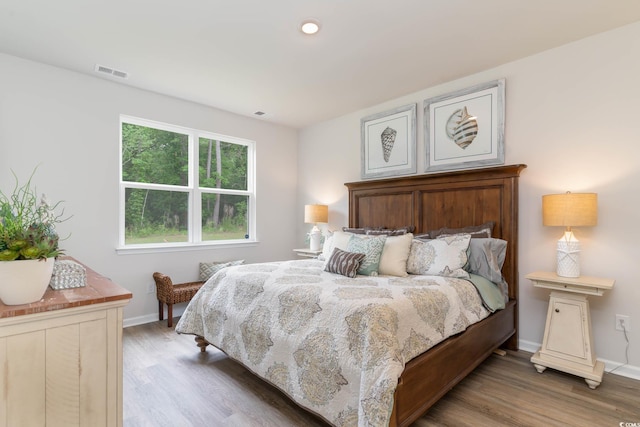 bedroom with dark hardwood / wood-style flooring