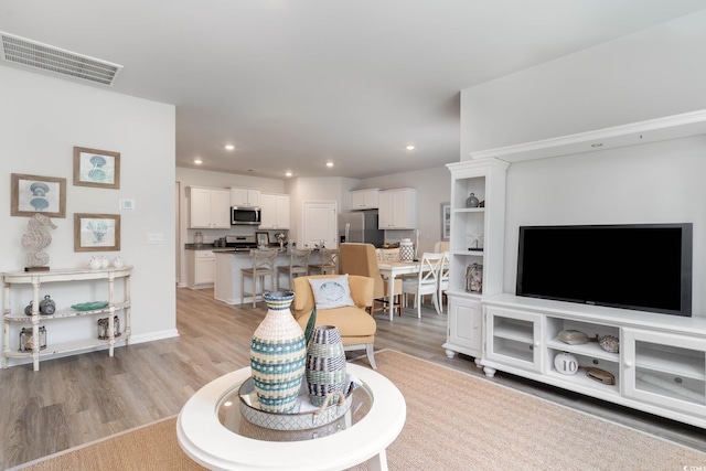 living room with light hardwood / wood-style flooring