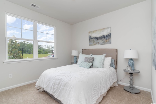 bedroom featuring carpet flooring and multiple windows