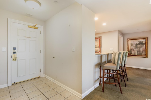 foyer entrance with light tile patterned floors