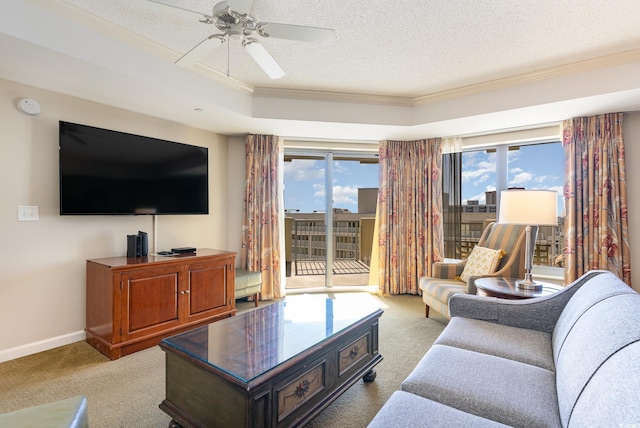 living room with a textured ceiling, light colored carpet, ceiling fan, and ornamental molding