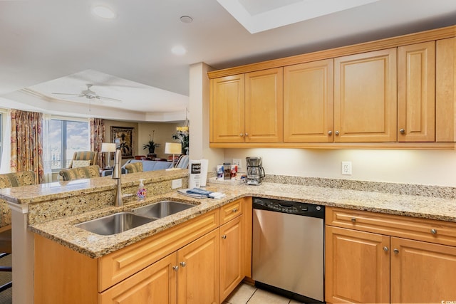 kitchen with light stone countertops, ceiling fan, sink, stainless steel dishwasher, and kitchen peninsula