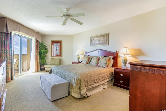 bedroom featuring a textured ceiling, ceiling fan, and light carpet