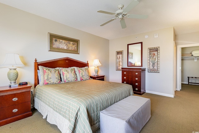 carpeted bedroom featuring ceiling fan and a closet