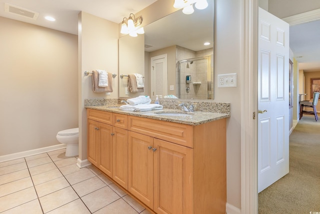 bathroom with tile patterned flooring, vanity, toilet, and a shower with door