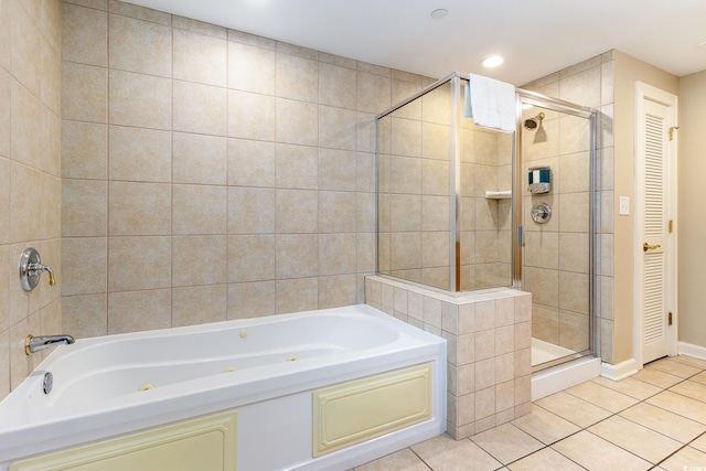 bathroom with tile patterned floors and shower with separate bathtub