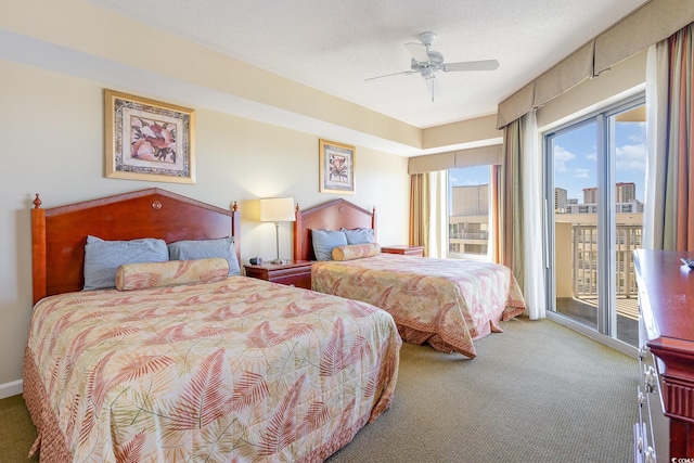 carpeted bedroom featuring access to exterior, a textured ceiling, and ceiling fan