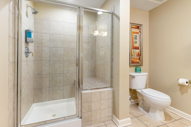 bathroom with toilet, tile patterned floors, and walk in shower