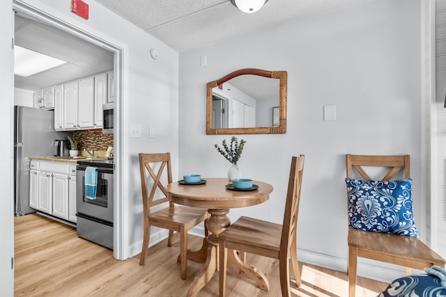 dining space with light hardwood / wood-style flooring