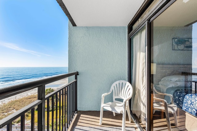 balcony with a water view and a beach view