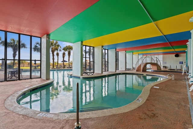 view of swimming pool featuring a patio area and a water view