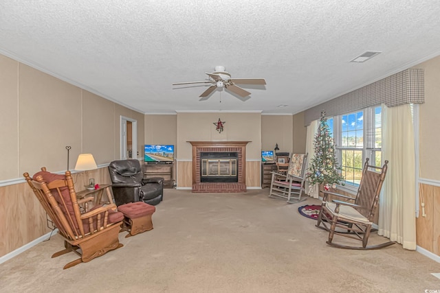 5080 Forest Dr, Loris, SC 29569 - living area with a textured ceiling, a fireplace, crown molding, ceiling fan, and carpet floors