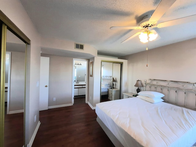 bedroom featuring ceiling fan, dark hardwood / wood-style floors, ensuite bathroom, a textured ceiling, and a closet