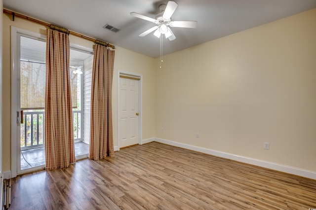 spare room featuring ceiling fan and light wood-type flooring