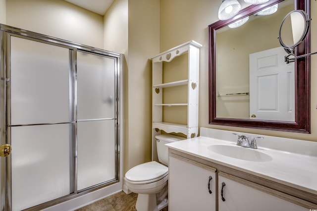 bathroom featuring tile patterned floors, vanity, an enclosed shower, and toilet