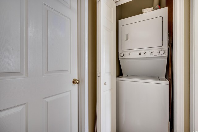 washroom with stacked washer and dryer