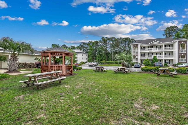 view of community featuring a gazebo and a yard