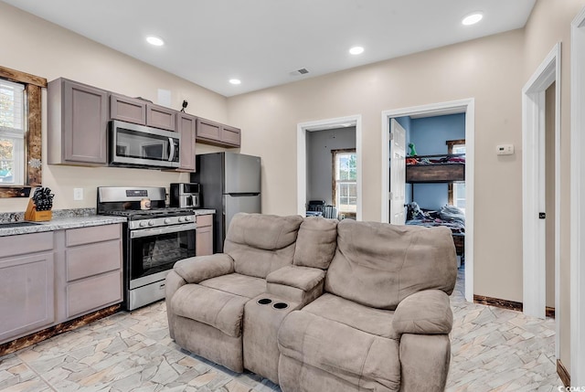 kitchen featuring gray cabinets, plenty of natural light, and stainless steel appliances