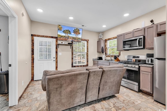 interior space featuring gray cabinets, sink, and appliances with stainless steel finishes