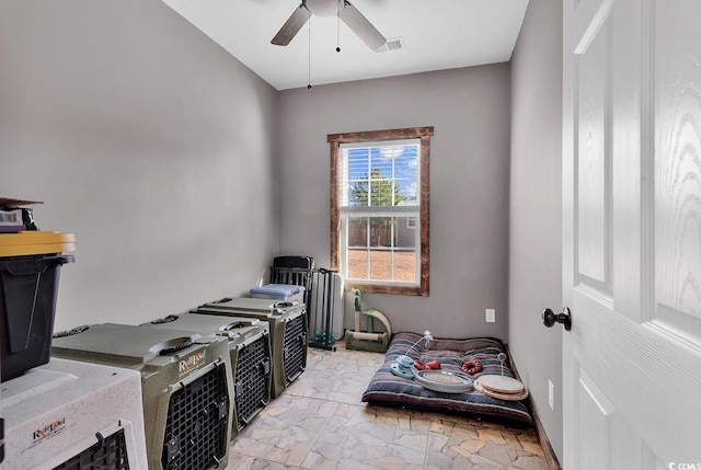 interior space with ceiling fan