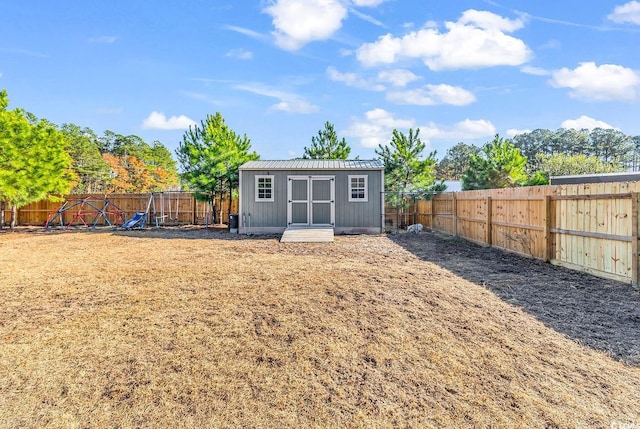 rear view of property featuring an outdoor structure