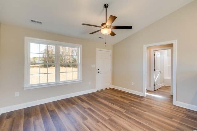 unfurnished room with ceiling fan, dark hardwood / wood-style flooring, and vaulted ceiling