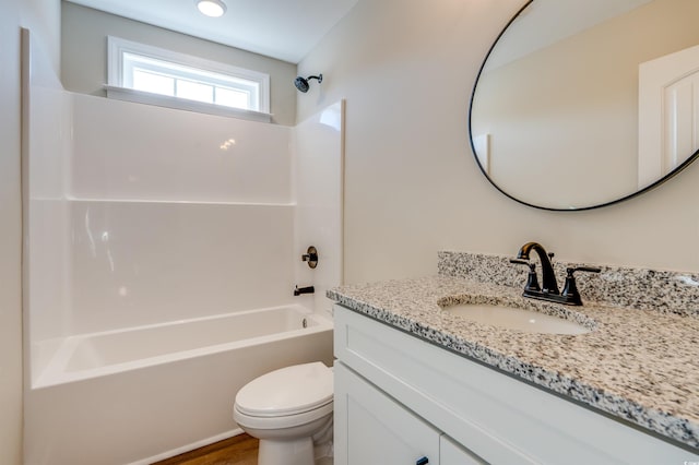 full bathroom with toilet, vanity, wood-type flooring, and washtub / shower combination