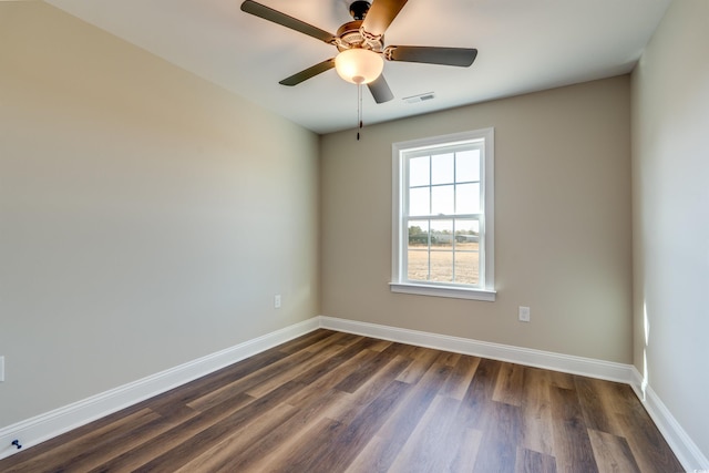 spare room with ceiling fan and dark hardwood / wood-style flooring