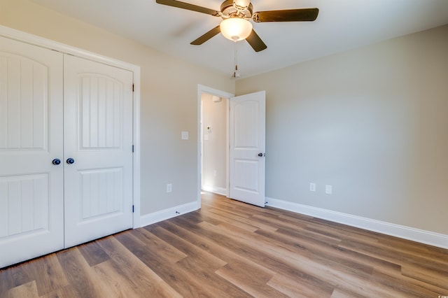 unfurnished bedroom featuring a closet, ceiling fan, and light hardwood / wood-style flooring