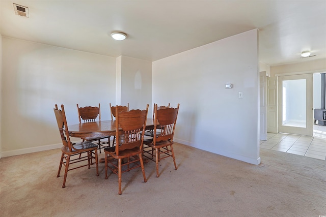 dining room featuring light colored carpet