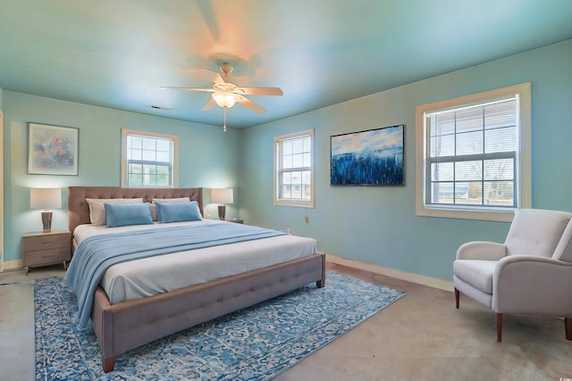 bedroom with ceiling fan, carpet floors, and multiple windows