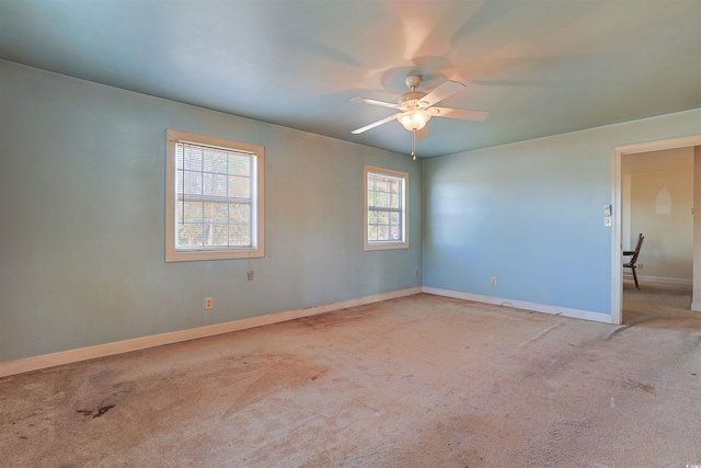 unfurnished room with ceiling fan and light colored carpet