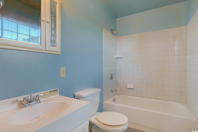 full bathroom with tiled shower / bath combo, toilet, and vanity